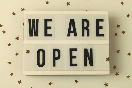 light box with text we are open on white background with small stars , reopening after covid-19 shutdown conceptの写真素材
