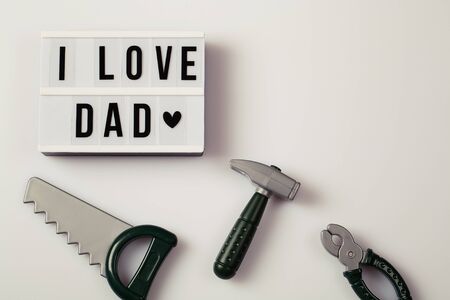 i love dad, Father's Day lightbox message with toy tools for repair saw nippers hammer . top view flat lay copy spaceの写真素材