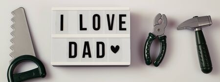 i love dad, Father's Day lightbox message with toy tools for repair saw nippers hammer . top view flat lay bannerの写真素材