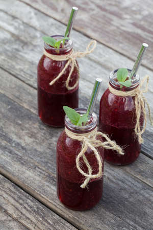 healthy detox beet smoothie in jar on wood background . healthy food concept