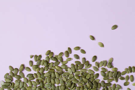 top view of pumpkin seeds on purple background. Concept of healthy diet. Super food. copy spaceの写真素材