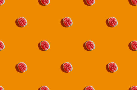 sunlight pattern made with marmalade in form of brain on bright orange background. Funny holiday...