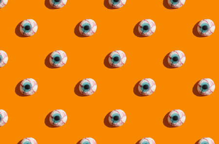 sunlight pattern made with marmalade in form of monster eyes on bright orange background. Funny...
