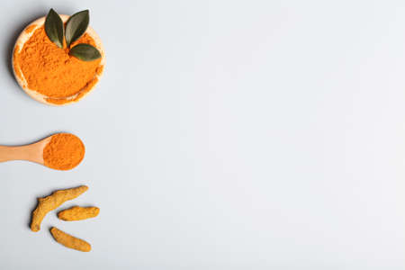 health care lifestyle concept. Curcuma Longa or turmeric powder in bowl with green leaf, wooden...
