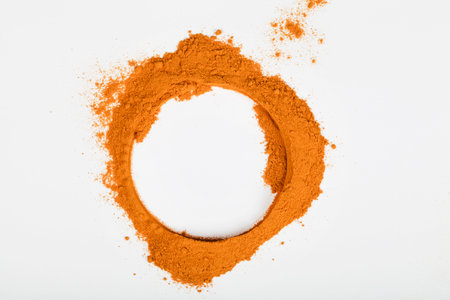 yellow curcuma or turmeric powder on white background. top view. copy space. spice and medicinal...