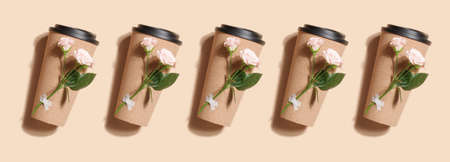 reusable eco coffee or tea cup with rose pattern on beige background. Sustainable lifestyle. Eco...