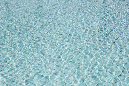 Summer background. Surface of blue swimming pool. ripped water. Minimal nature background.