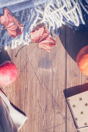 Autumn composition. pumpkin, apple, white sweater and plaid on wooden background. Autumn, fall...