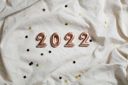 numbers 2022 on grey crumpled textiles. top view new year celebration concept. party background.の写真素材