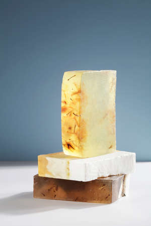 Set of beautiful handmade natural soap on white and blue background. organic simple, eco friendly, spa skincare concept. copyspace.の写真素材