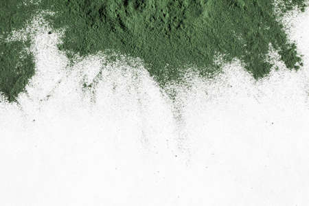 natural additives and superfoods. green spirulina algae powder on white background. healthy lifestyle concept. organic food. copy spaceの写真素材