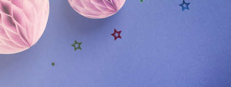 Purple Scandinavian modern paper honeycomb decoration on blue background.Concept of happiness, joy, birthday, party, advertisement, copy space bannerの写真素材