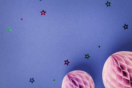 Purple Scandinavian modern paper honeycomb decoration on blue background.Concept of happiness, joy, birthday, party, advertisement, copy spaceの写真素材