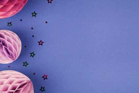 Purple Scandinavian modern paper honeycomb decoration on blue background.Concept of happiness, joy, birthday, party, advertisement, copy spaceの写真素材