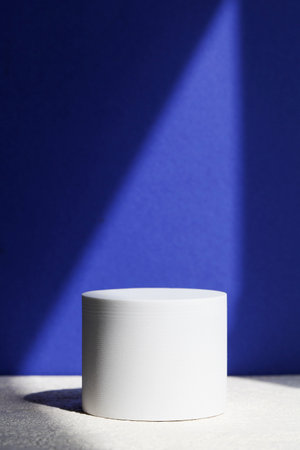 podium for product display on blue background with deep shadow. product background, pedestal, stage for product. copyspace.の写真素材