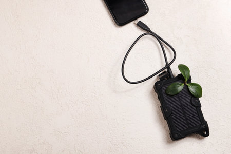 cheapest source of electricity. power box, portable solar battery for phone on white background. innovative solutions concept. copy spaceの写真素材