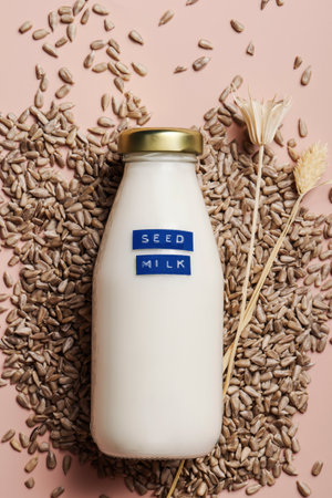 Sunflower seed milk in bottle on beige background. copy space. Raw diet meal. Healthy vegetarian food and lifestyle. eco friendly productの写真素材
