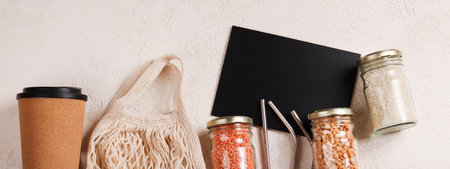 Zero waste lifestyle concept.Responsible consumption, healthy food.black board for text and reusable cup, mesh , glass jar, reusable strawsの写真素材
