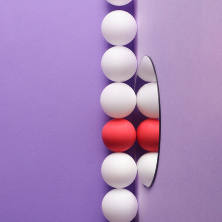 dimensional compositions of geometric shapes concept.white and crimson balls on mirror on purple...