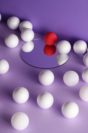 dimensional compositions of geometric shapes concept.white and crimson balls on mirror on purple background. copyspace. abstract wallpaper styleの写真素材
