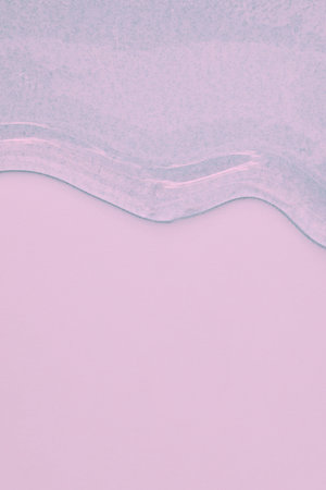 viscous pure transparent cosmetic gel on pink background. tactile , skincare, cosmetics concept. flow soft texture. element for advertising, designの写真素材