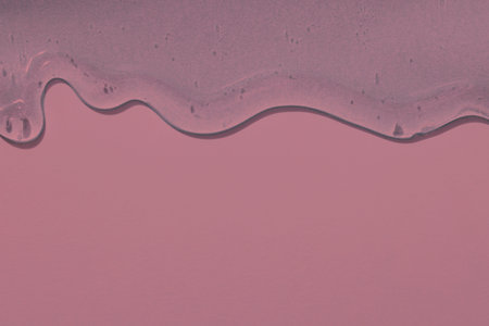 viscous pure transparent cosmetic gel on pink background. tactile , skincare, cosmetics concept. flow soft texture. element for advertising, designの写真素材