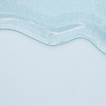 viscous pure transparent cosmetic gel on blue background. tactile, skincare, cosmetics concept. flow soft texture. element for advertising, designの写真素材