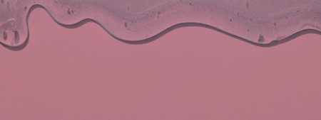 viscous pure transparent cosmetic gel on pink background. tactile, skincare, cosmetics concept. flow soft texture. element for advertising, designの写真素材