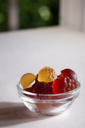chewable supplements, nutritional gummies, edible health concept. colorful marmalades in glass on...