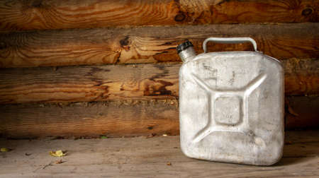 Aluminum can with gasoline on wooden background. Biodiesel. Environmental protection. Ecologyの写真素材