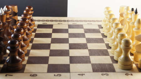 Chess game. White and black pieces on chess board. International chess day 20 julyの写真素材