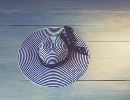 Woman's accessories, top view. Concept image. Women's hat on woodenの写真素材