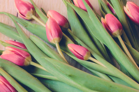 Spring bouquet of flowers of pink tulips on wooden outdoors - imageの写真素材