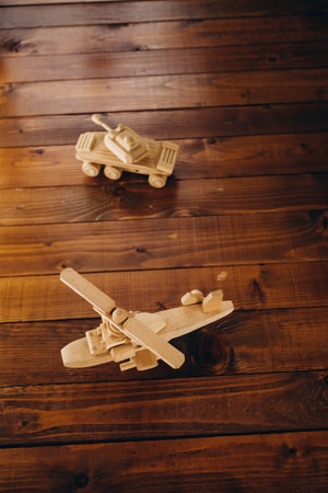 Wooden toy airplane on a wooden background. The concept of travel, vacation, tourism.の写真素材