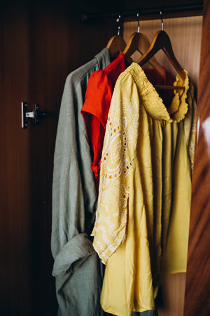 Women's clothing on hangers in the wardrobe. Selective focus.の写真素材