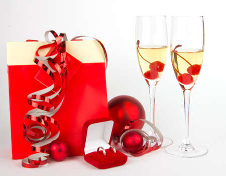 Christmas prresents and glasses in red on whiteの写真素材