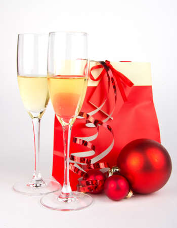 Christmas present in red and glasses on whiteの写真素材