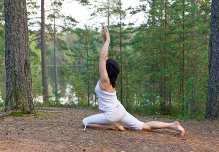 Woman in yoga one legged king pigeon poseの写真素材