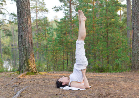 Woman in yoga shoulder stand poseの写真素材