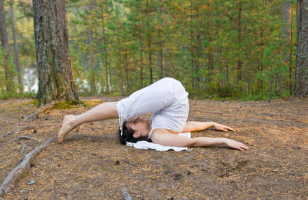Woman in yoga plough poseの写真素材