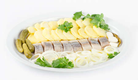 Plate with portion of herring fish fillets with potato and onionの写真素材
