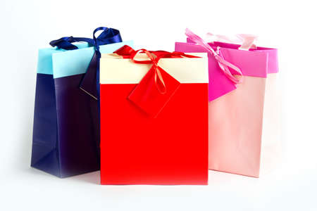 Blue red pink paper bags for presents on whiteの写真素材