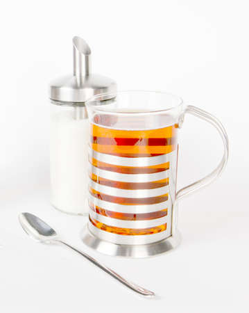 A cup of tea with sugar and spoon on whiteの写真素材