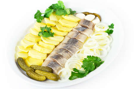 Portion of herring fish fillets with potato and onionの写真素材