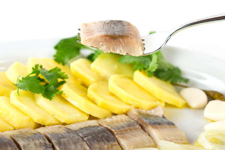 Portion of herring fish fillets with potato and onionの写真素材