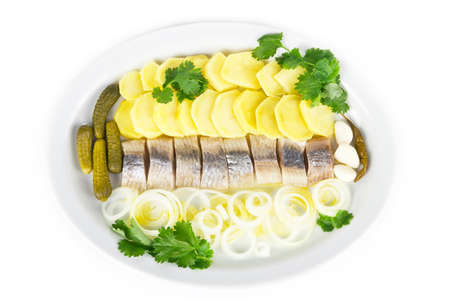 Portion of herring fish fillets with potato and onionの写真素材