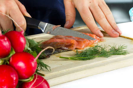 Woman cooking fishの写真素材