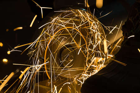 sharpening and cutting of iron by abrasive disk machineの写真素材