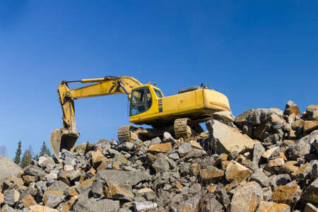 Excavator at rock quarry
