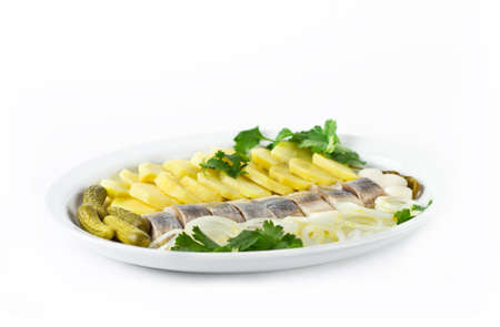 Portion of herring fish fillets with potato and onionの写真素材